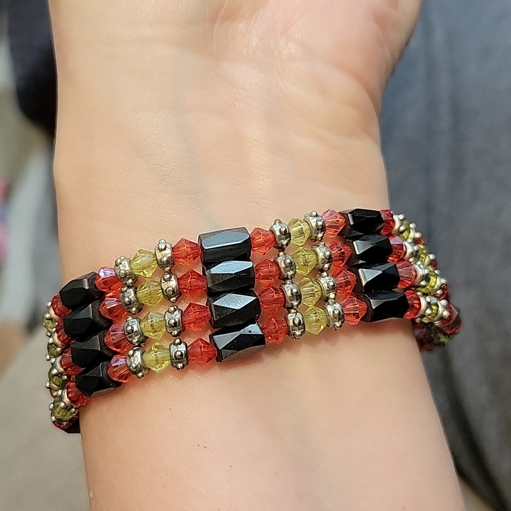 Magnetic bracelet with red/green/black and silver beads.
